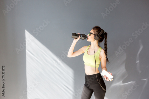Girl in a yellow swimsuit in the gym teaches yoga for a healthy life. Exercise for every day
