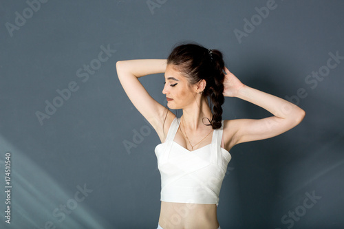 Girl in a yellow swimsuit in the gym teaches yoga for a healthy life. Exercise for every day
