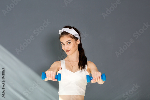 Girl in a yellow swimsuit in the gym teaches yoga for a healthy life. Exercise for every day
