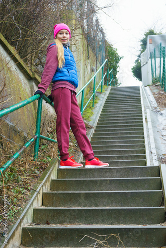 Woman exercising on stairs outside during autumn