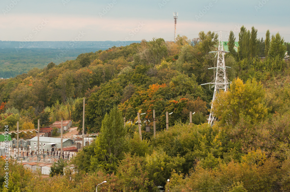 Obraz premium High-voltage power transmission towers among the trees,