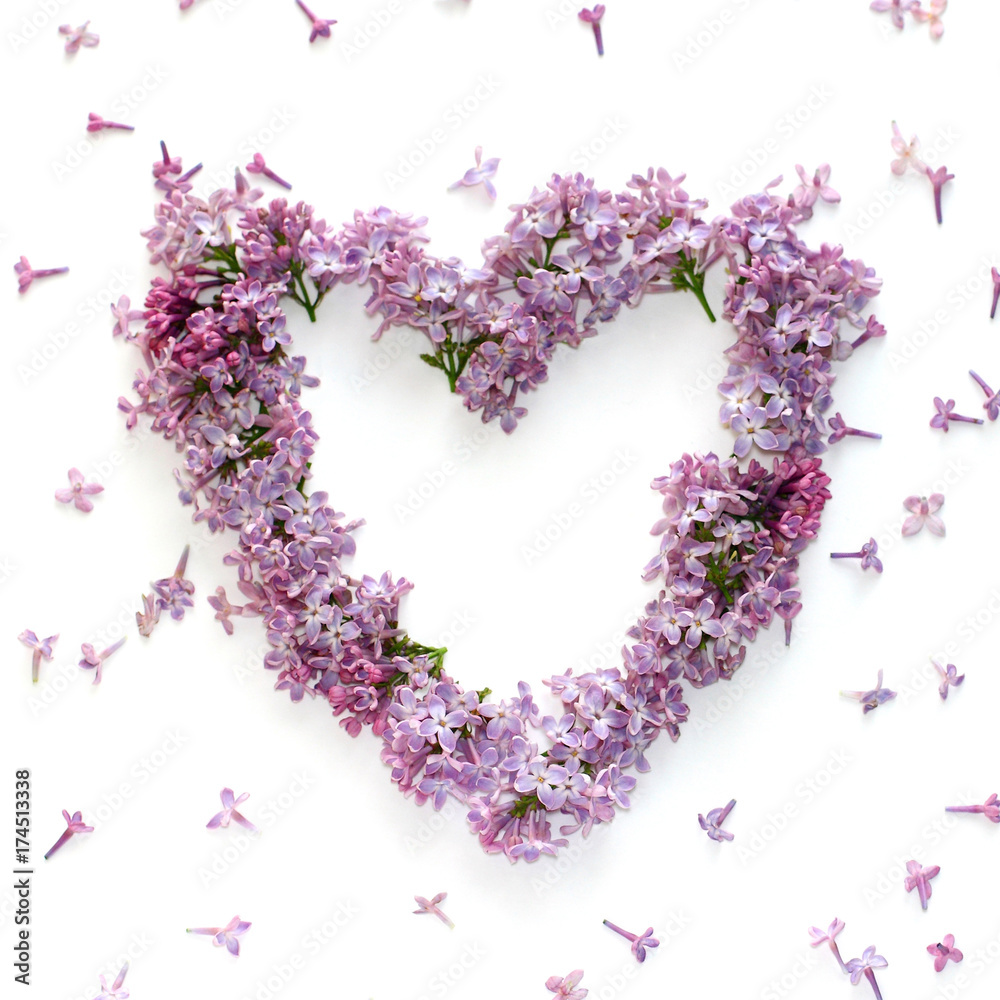 frame in the form of heart fresh lilac flowers on white, flat lay, top view.
