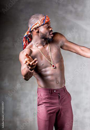 
African American dancing breakdance at a health sports center. Man teaches fitness exercises in the gym
