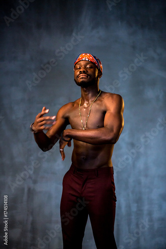 
African American dancing breakdance at a health sports center. Man teaches fitness exercises in the gym