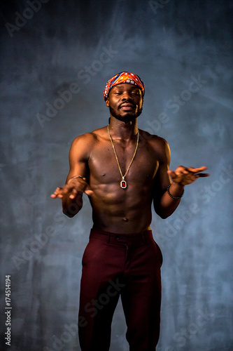 
African American dancing breakdance at a health sports center. Man teaches fitness exercises in the gym