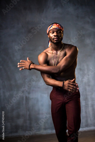 
African American dancing breakdance at a health sports center. Man teaches fitness exercises in the gym