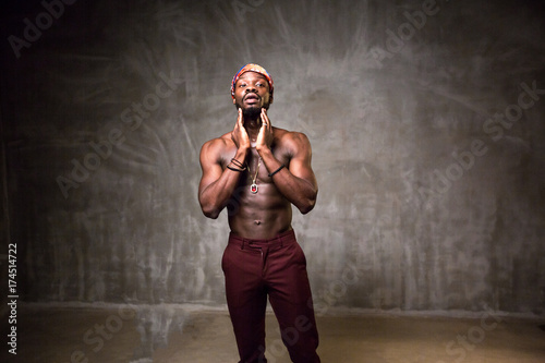 
African American dancing breakdance at a health sports center. Man teaches fitness exercises in the gym