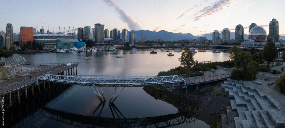 Aerial panoramic view of the modern city building skyline during a vibrant summer sunrise. Taken in False Creek, Downtown Vancouver, British Columbia, Canada.
