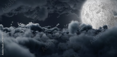 Moon shining between clouds 