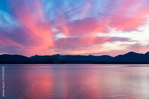 Fototapeta Naklejka Na Ścianę i Meble -  Alaskan coastline sunset with mountain silhouette