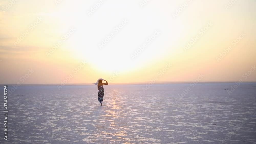 A cheerful girl at sunset at Lake Salt. A cheerful girl at sunset at Lake Salt.