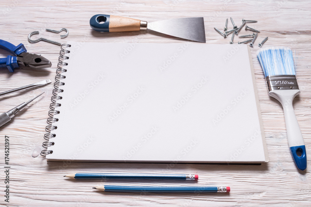 Constructor tools and notebook on wooden background Constructor tools and notebook on wooden background