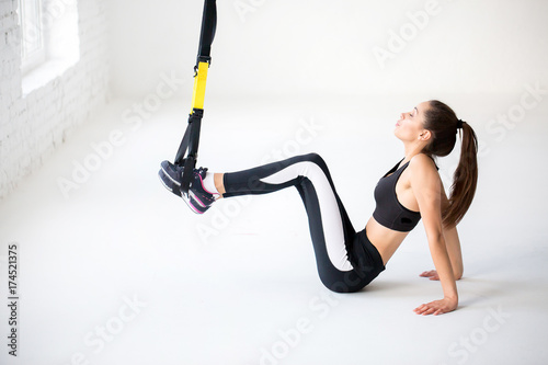 Fly yoga in a white gym. Gymnastics performs physical exercises fly-yoga