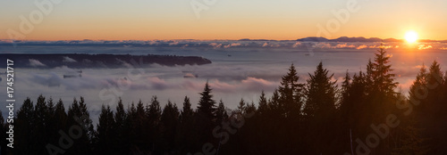 Beautiful panoramic landscape view overlooking Burrard Inlet during a vibrant cloudy sunset. Taken from Cypress Viewpoint  West Vancouver  British Columbia  Canada.  