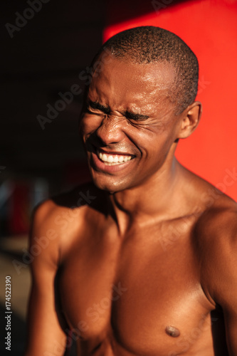 Portrait of a smiling happy half naked african sportsman laughing © Drobot Dean