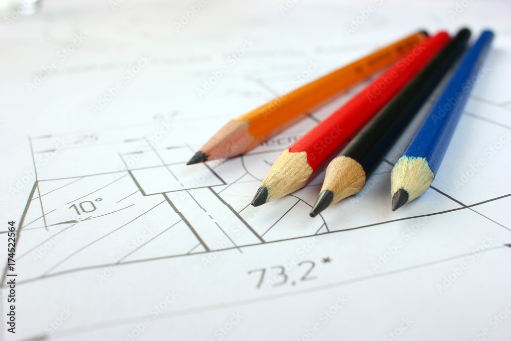 Open drawings with a pencil. Engineering and design. Construction projects. Planning. Open drawings with a pencil. Engineering and design. Construction projects. Planning.