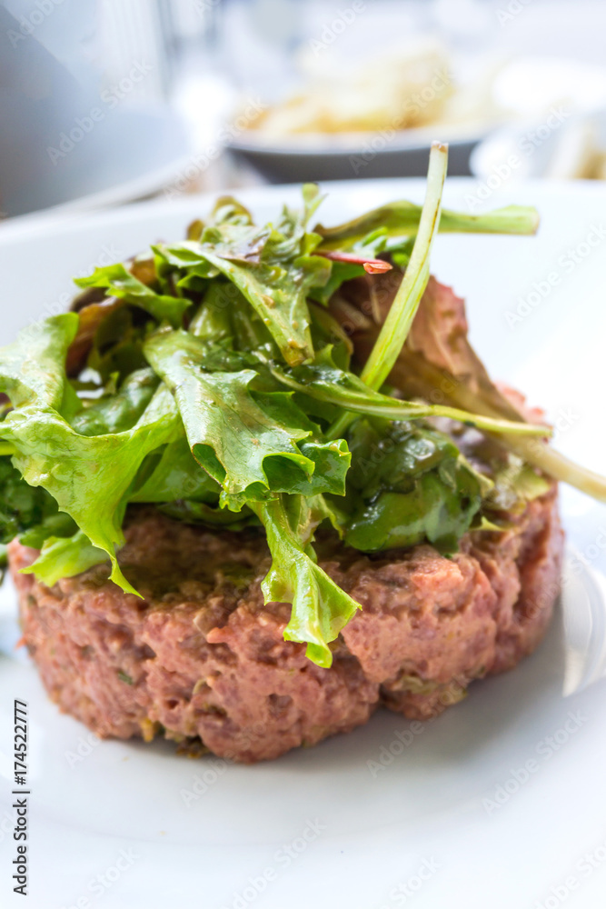 tasty Steak tartare (Raw beef) - classic steak tartare on white plate tasty Steak tartare (Raw beef) - classic steak tartare on white plate