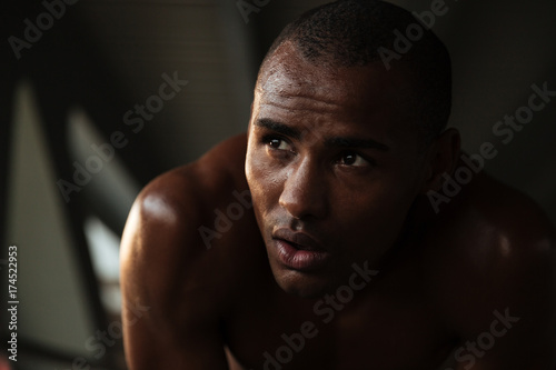 Close up portrait of a young tired sweaty african sportsman photo