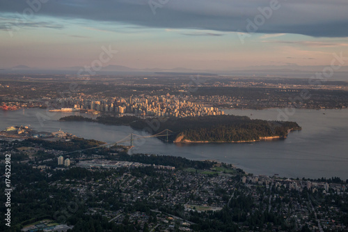 Aerial view of Stanley Park and Downtown City during a vibrant sunset. Taken in Vancouver, British Columbia, Canada.