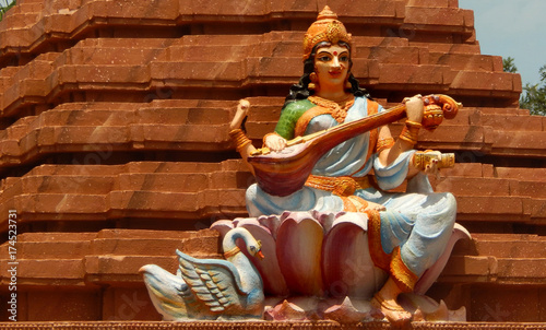 Statue of Hindu Goddess Saraswati play music on veena, with hansa ,her mount,in a  temple 