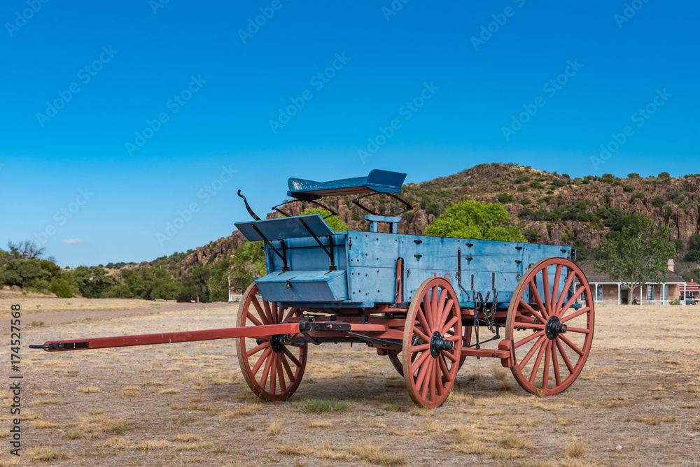 Close up view of old blue chuck wagon with red wheels