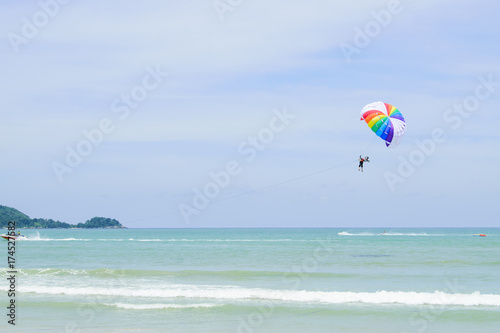 Parachutes in the sky float over the Andaman Sea.