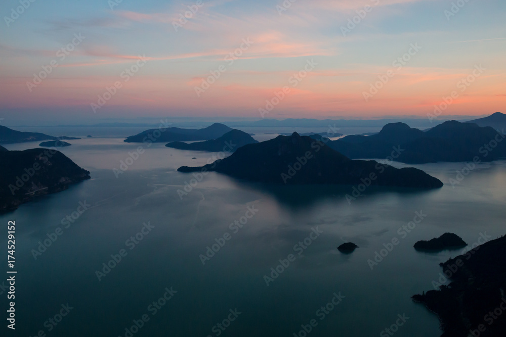Aerial view of Howe Sound during a vibrant summer sunset. Taken North of Vancouver, British Columbia, Canada.
