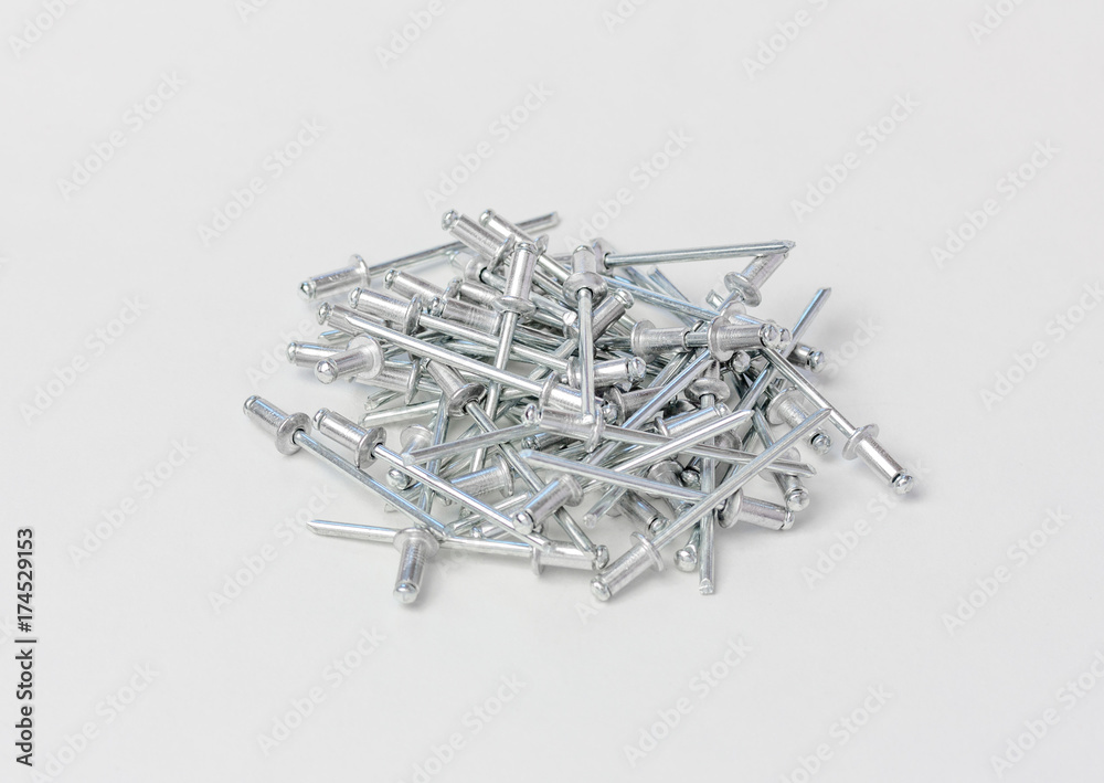 rivets for the riveter or manual and electric rivet gun on a gray background rivets for the riveter or manual and electric rivet gun on a gray background