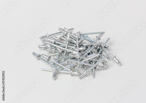 rivets for the riveter or manual and electric rivet gun on a gray background