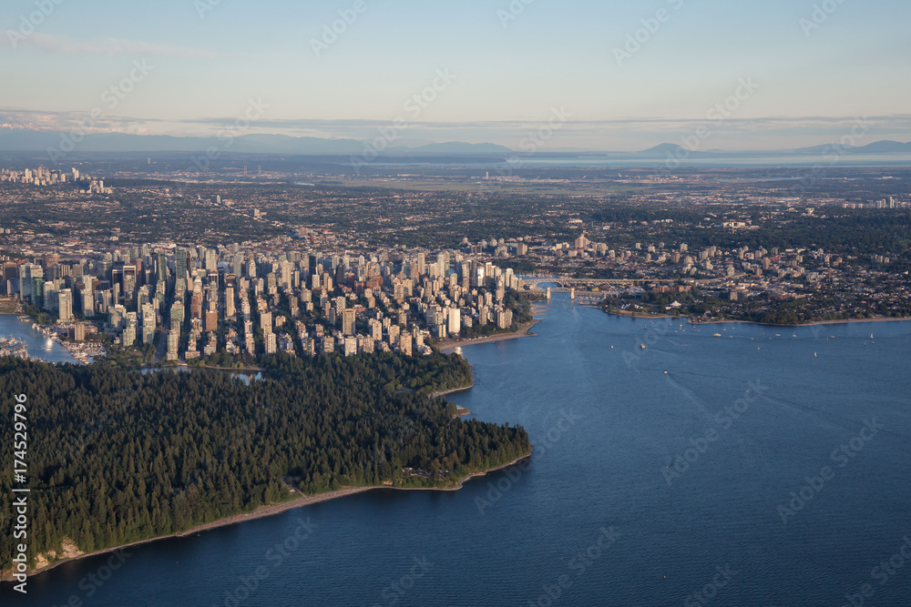 Naklejka premium Aerial view from an airplane of Downtown City during a summer sunset. Taken in Vancouver, British Columbia, Canada. 