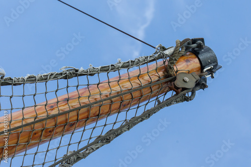Bowsprit tree in front of a fishing boat with a hanging net