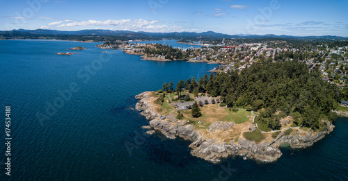 Aerial panoramic landscape view of a beautiful rocky shore on Pacific Coast. Taken in Saxe Point Park, Victoria, Vancouver Island, British Columbia, Canada.