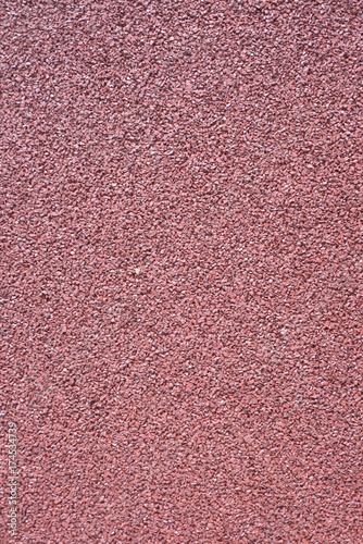 Small gravel, colored asphalt background closeup photo