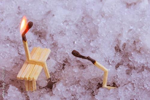 matches on snow background. Man asking for forgivness. woman sits on bench, man asks for forgiveness on his knees. Relationship problem concept photo