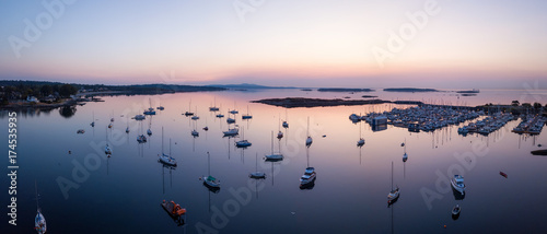Vászonkép Aerial panoramic view of sail boats parked in a marina during a vibrant sunrise