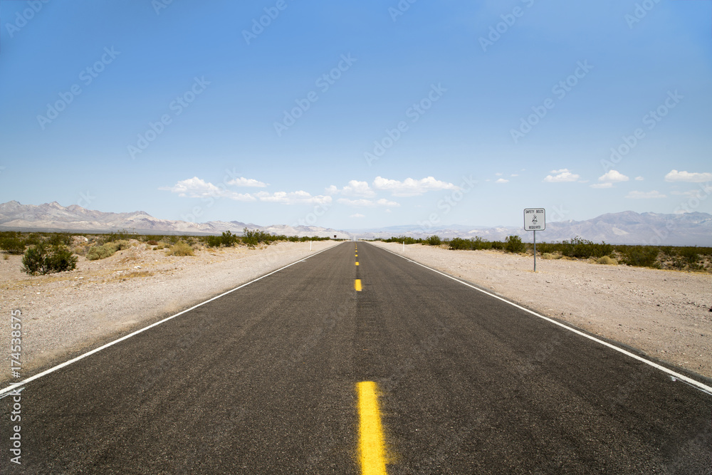 Fototapeta premium The never ending highway running through the California desert 