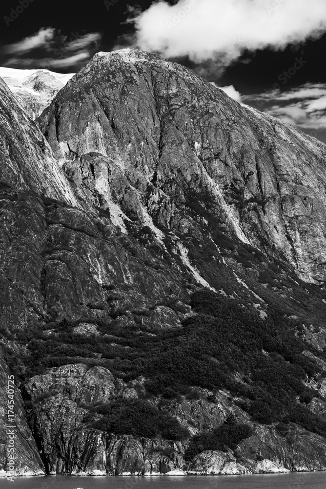 Fototapeta premium Monochrome view of alaskan seascape with snow capped mountains