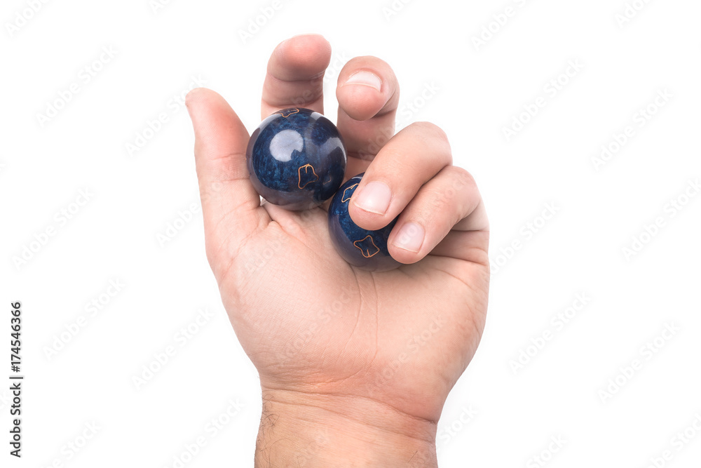 Chinese balls Yin Yan for health in hand isolated on white background Chinese balls Yin Yan for health in hand isolated on white background