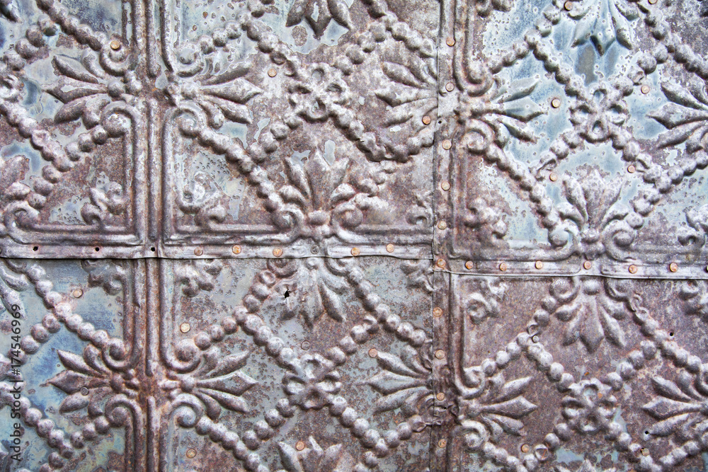 An unusual metal texture on the side of an abandoned building 