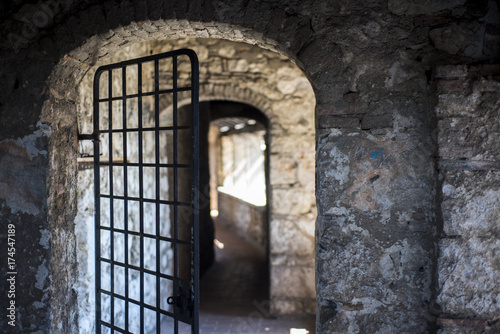 Stone room with an iron grating.