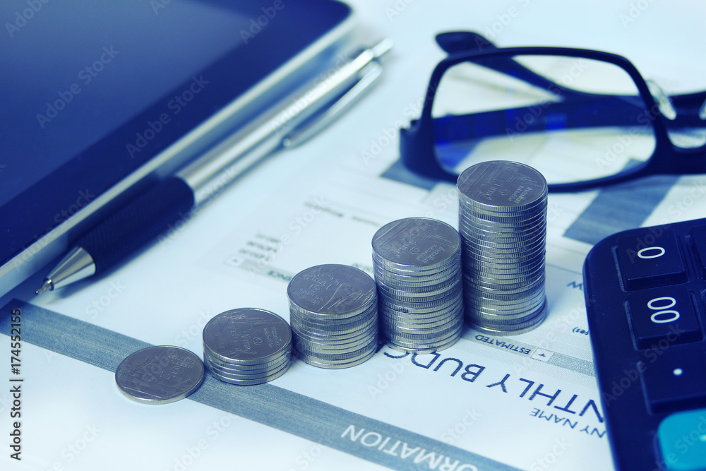 Coins stack shape growth lay on document paper on working table Coins stack shape growth lay on document paper on working table