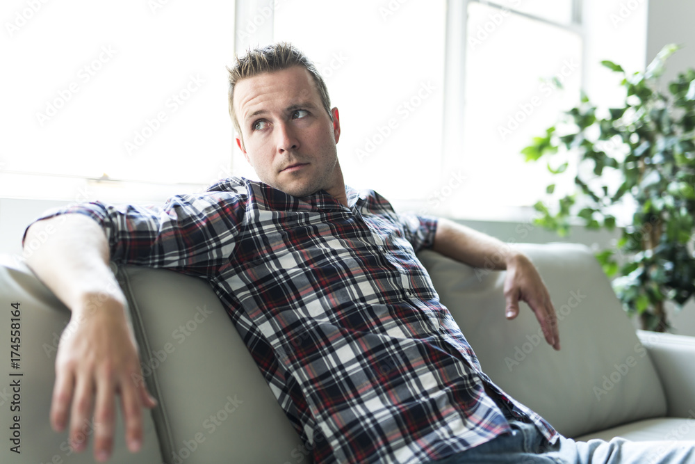 Fototapeta premium Man sitting in living room