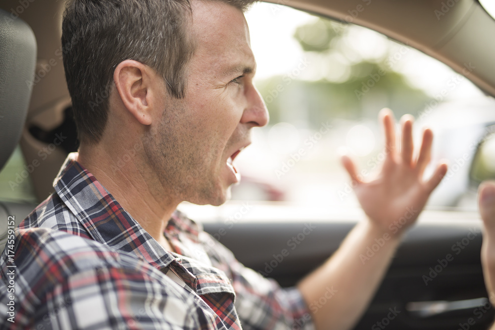 Fototapeta premium Irritated young man driving a car. Irritated driver