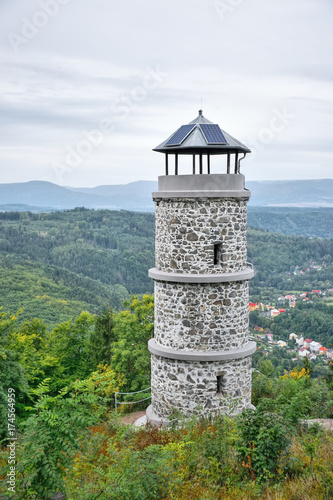 Stone lookout after reconstruction on top of Bucina hill with Ohre river valley and Ore mountains on background at beginning autumn czech