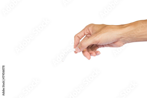 Conceptual man hand holding a cigarette isolated on white background with clipping path