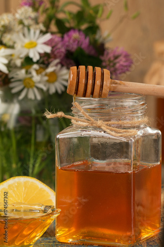 Honey in a pot or jar on a wooden table