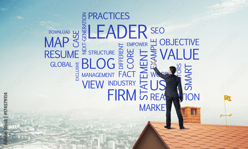 Young businessman standing on house roof and writing leadership Young businessman standing on house roof and writing leadership