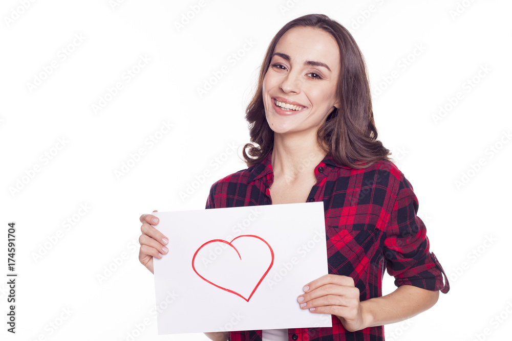 Young beautiful girl smiles and holds in her hands a white paper with an inscription i love you Young beautiful girl smiles and holds in her hands a white paper with an inscription i love you