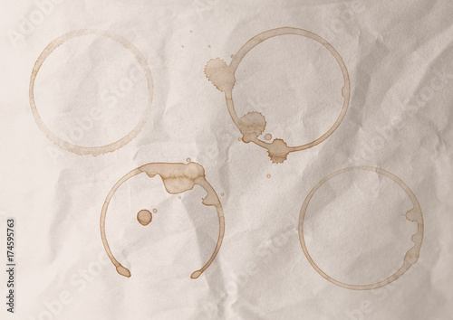 Circular coffee stains on a paper background