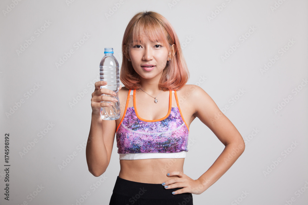 Beautiful Asian healthy girl with bottle of drinking water. Beautiful Asian healthy girl with bottle of drinking water.